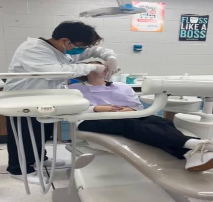 Students Edwin CanelXuya and Maeve Bailey of the Dental Assistant BOCES program practice taking molds of one another’s teeth