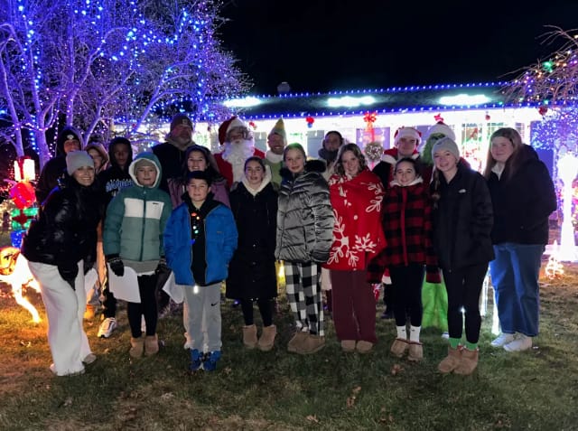Community members joined together December 22, 2025 to participate in Caroling for Carol.
