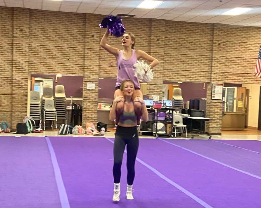 Cheerleaders Elise Flynn (bottom) and Eden Spelman (top) practicing their routine for their upcoming competition.